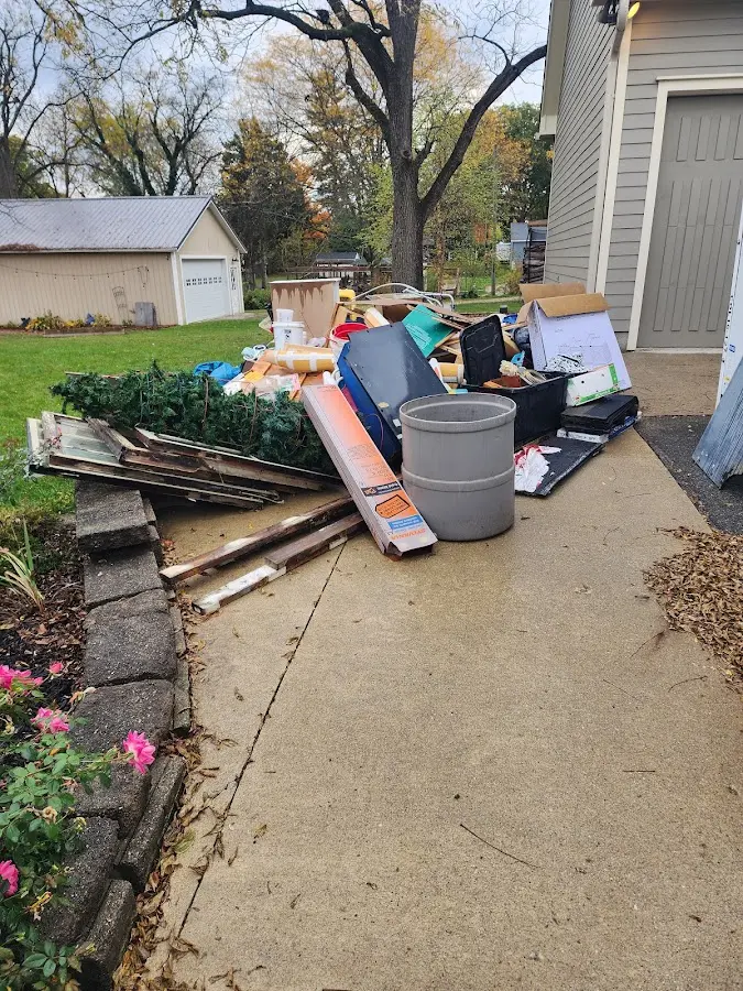 Dumpster being loaded with debris for Commercial Dumpster Rental in Alvin